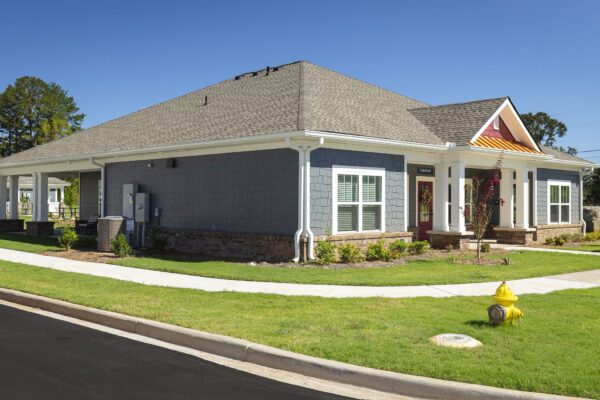 Kings Way clubhouse exterior with covered porch and landscaping